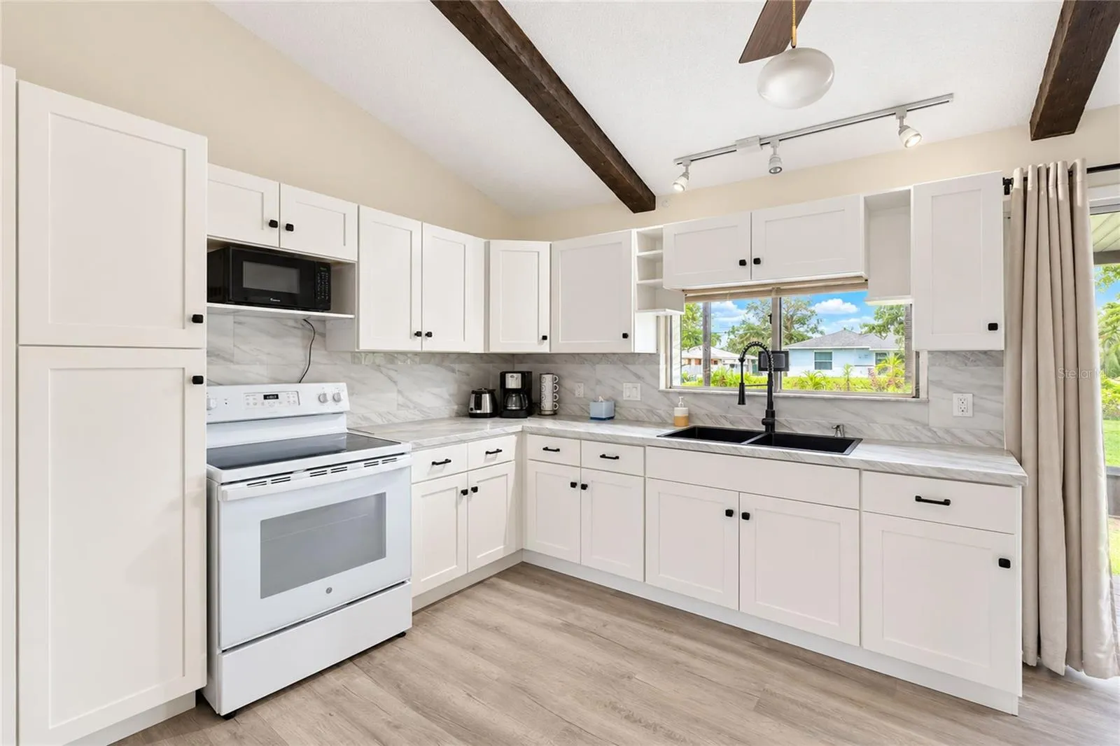 Kitchen with pass-through to the screened porch.
