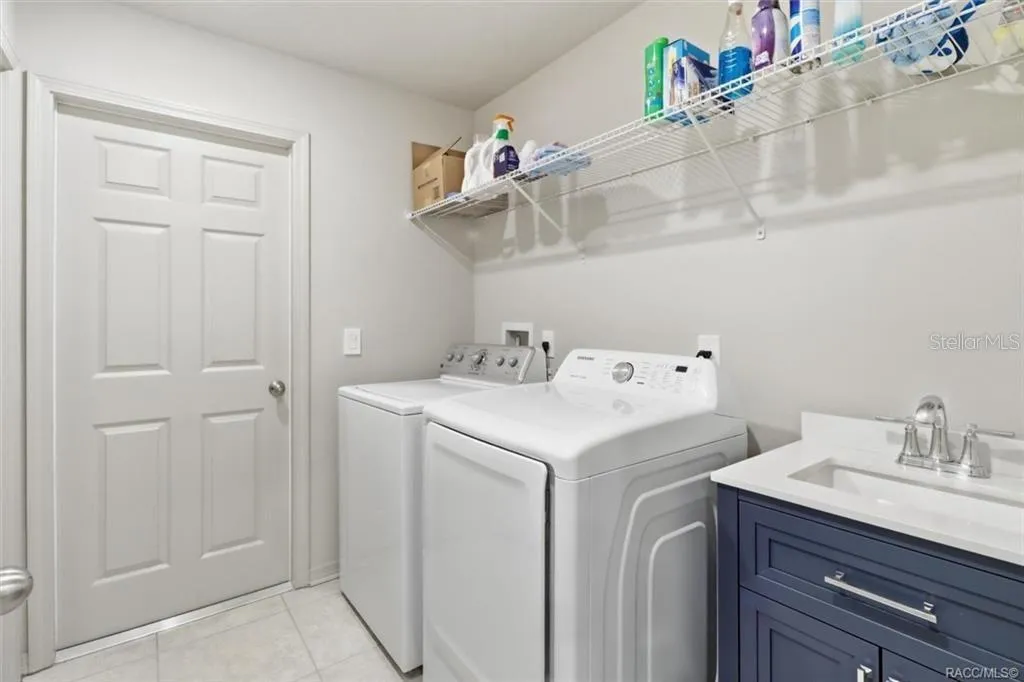Laundry Room w/ Sink and Door to Access the Garage