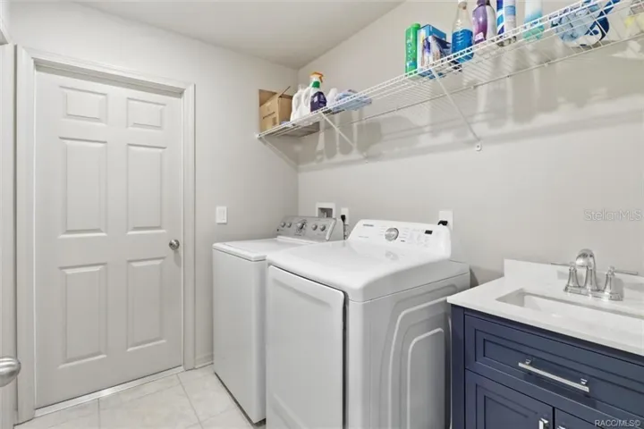 Laundry Room w/ Sink and Door to Access the Garage