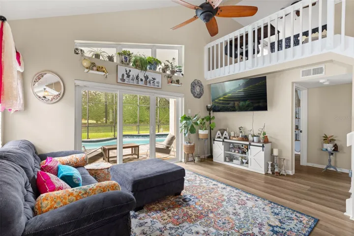 LIVING ROOM W/ ENTRY TO PRIMARY BEDROOM