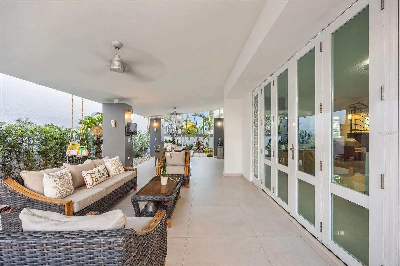 Room for everyone to gather on this covered terrace, with ceiling fans, dining for six, and the calming sound of the fountain