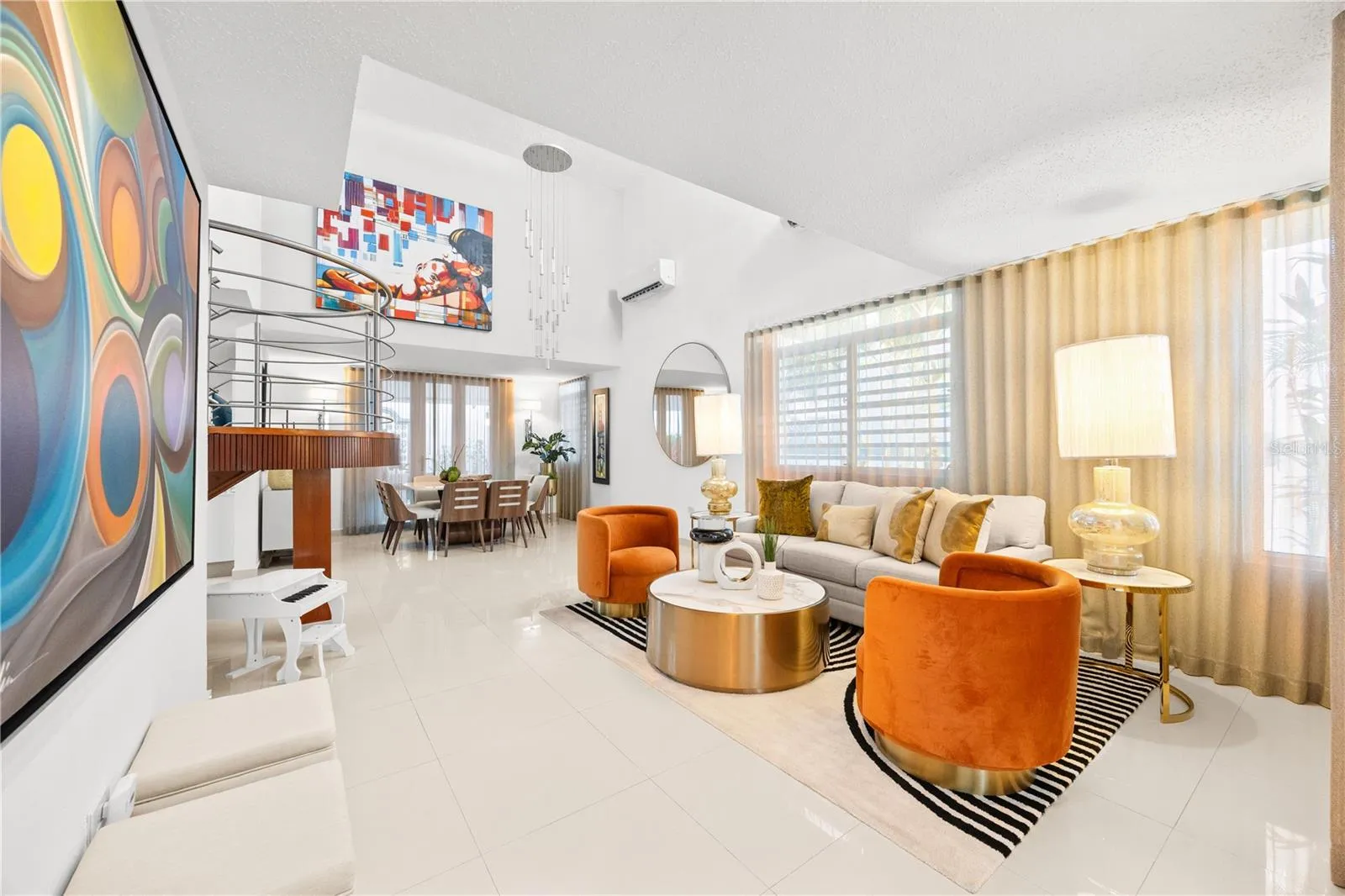 Open living and dining areas with double height ceilings and sweeping sightlines