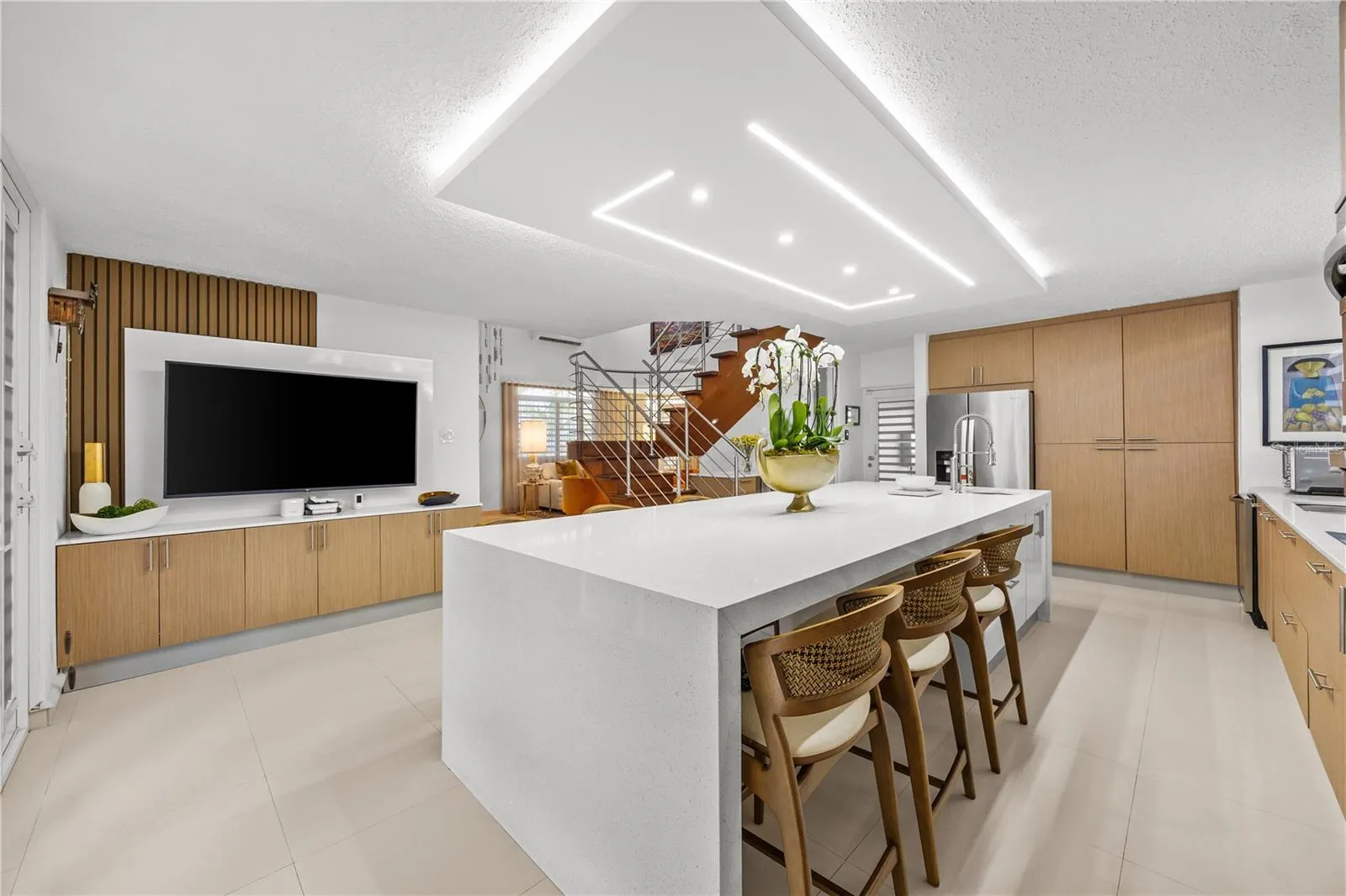 Designer kitchen with a slatted wood feature wall and ample custom storage, made for everyday living and entertaining