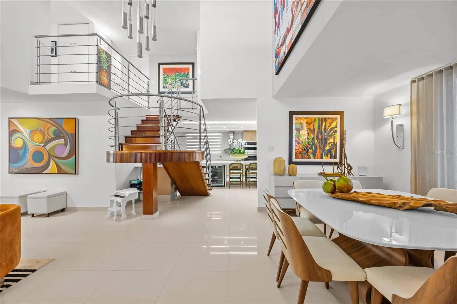 Bright, open living and dining space with a sculptural staircase