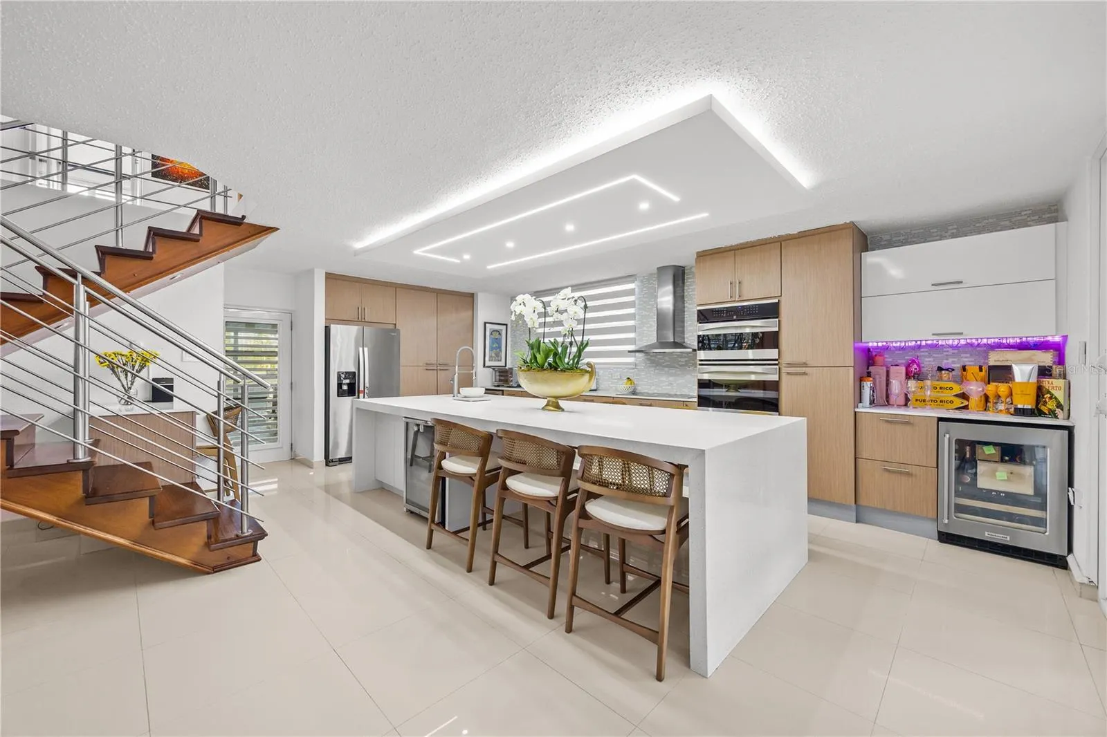 Chef's kitchen with impressive waterfall island and top of the line appliances