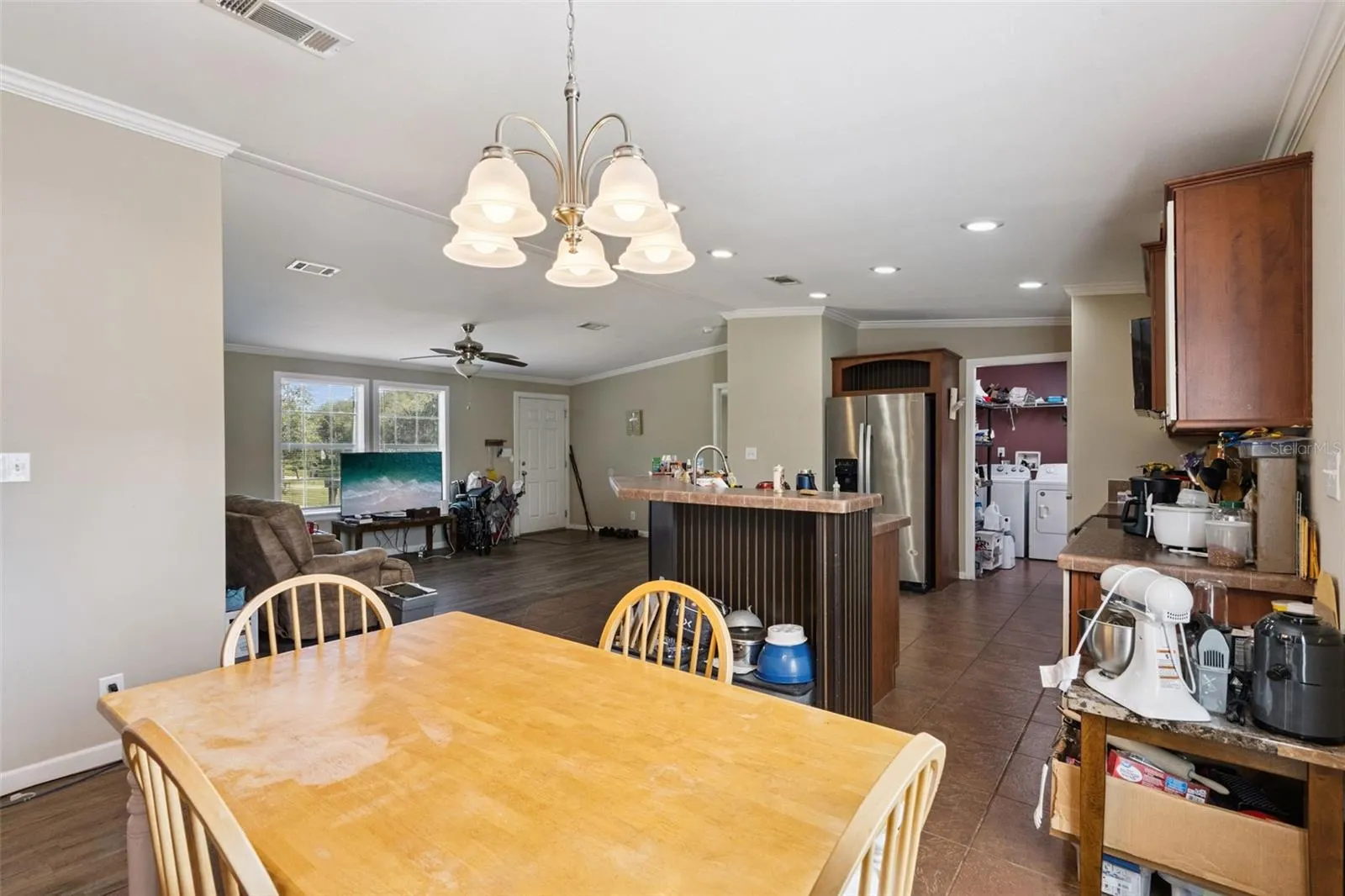 Dining area features crown molding and vaulted ceilings