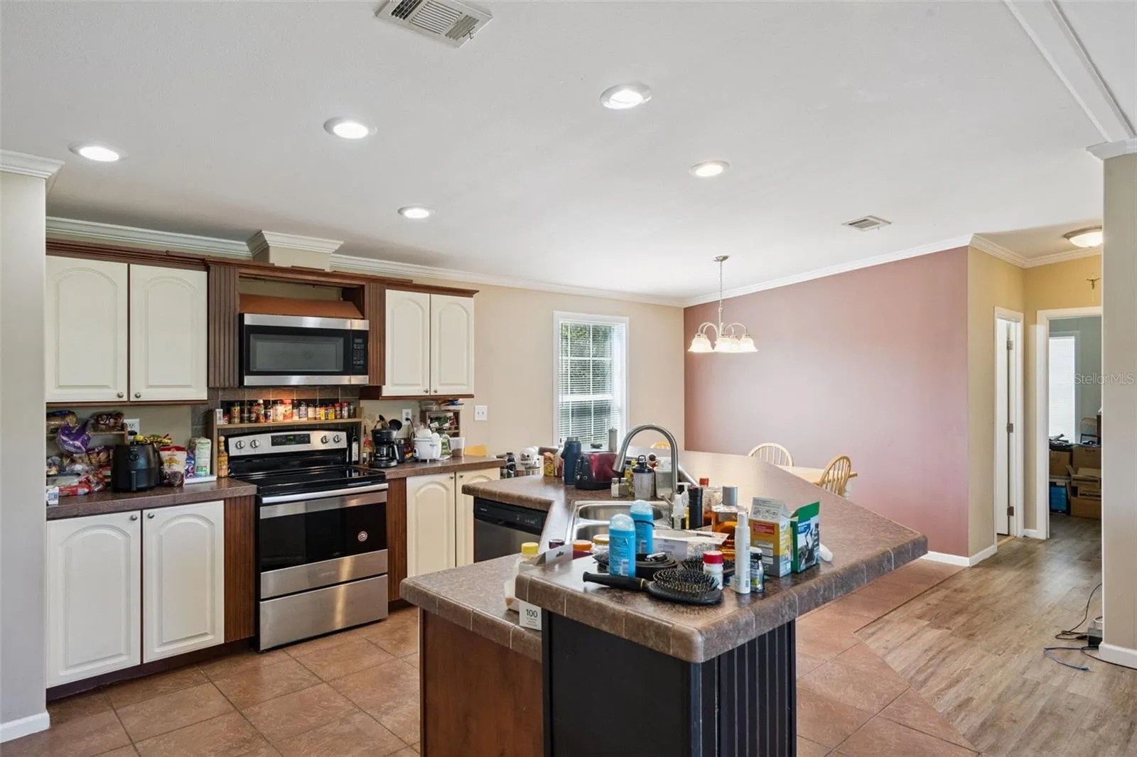 Kitchen features White Cabinetry accented with crown molding and stainless steel appliance package