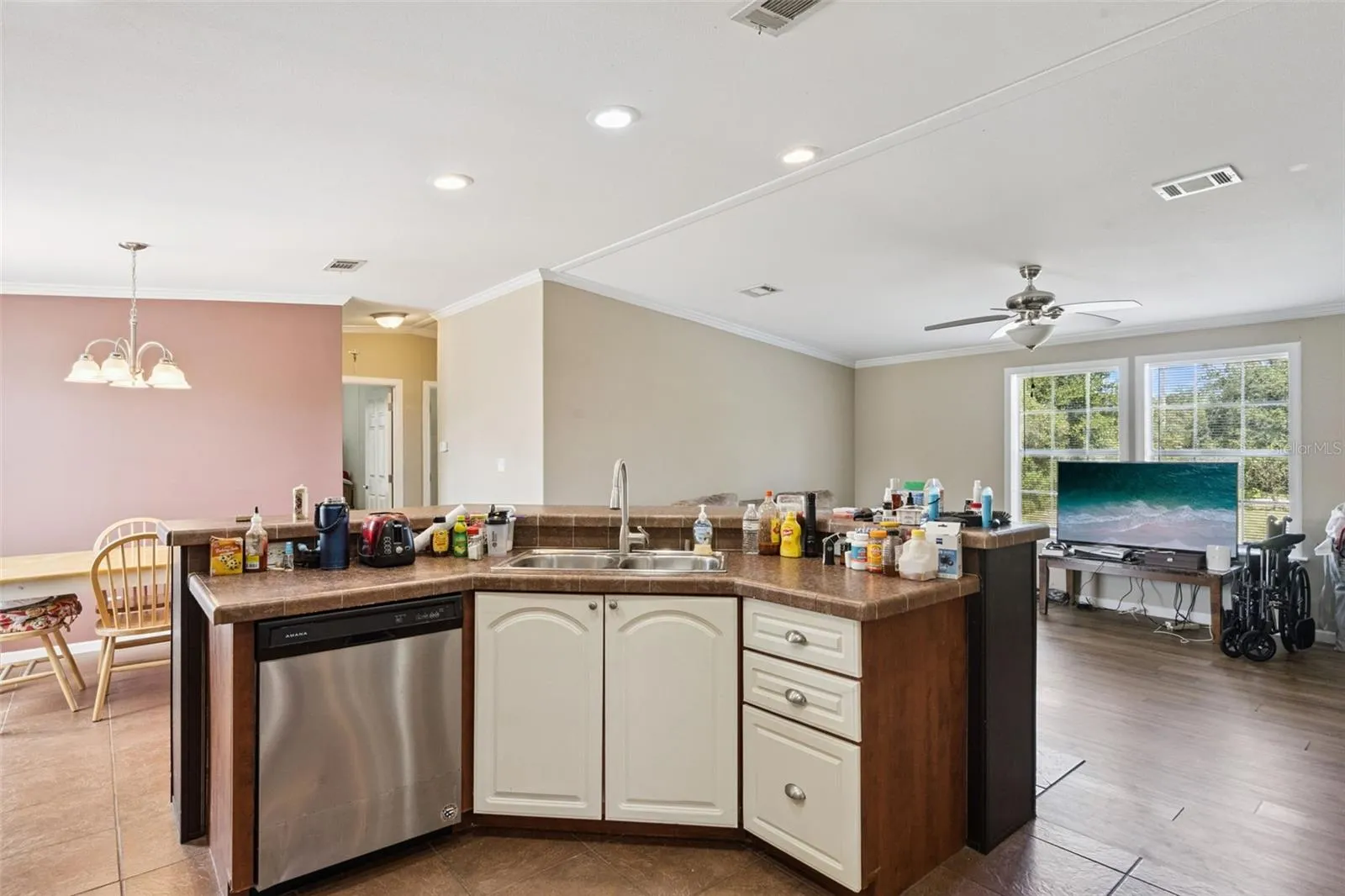 Large center island with stainless steel sink and gooseneck faucet