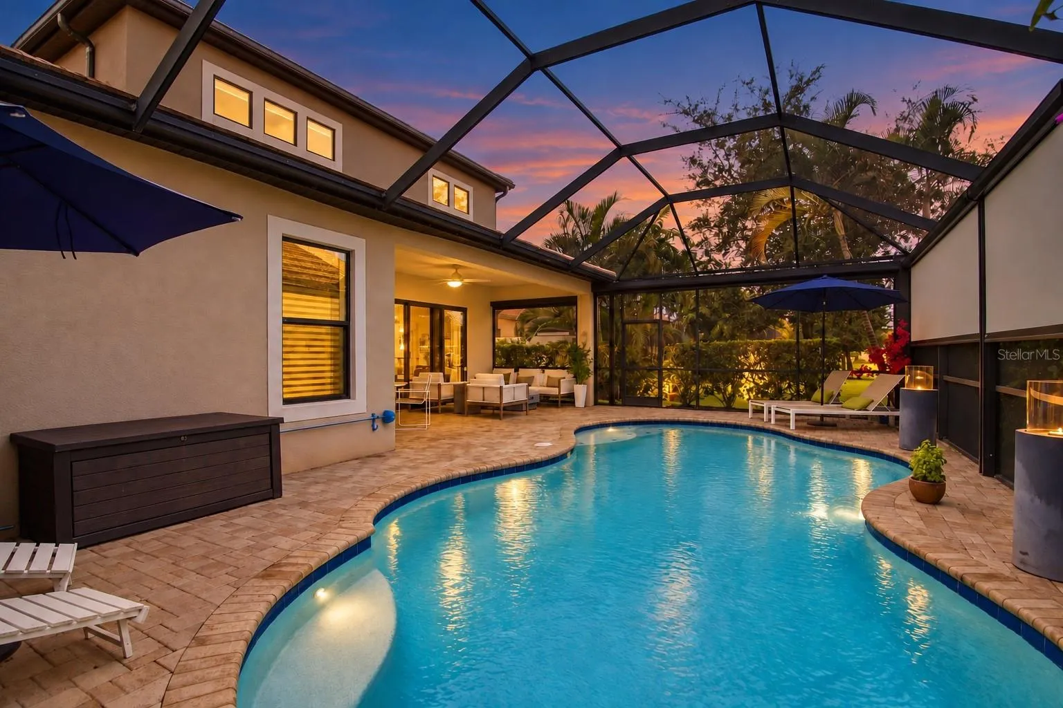 Twilight exterior with warm window and entry lighting