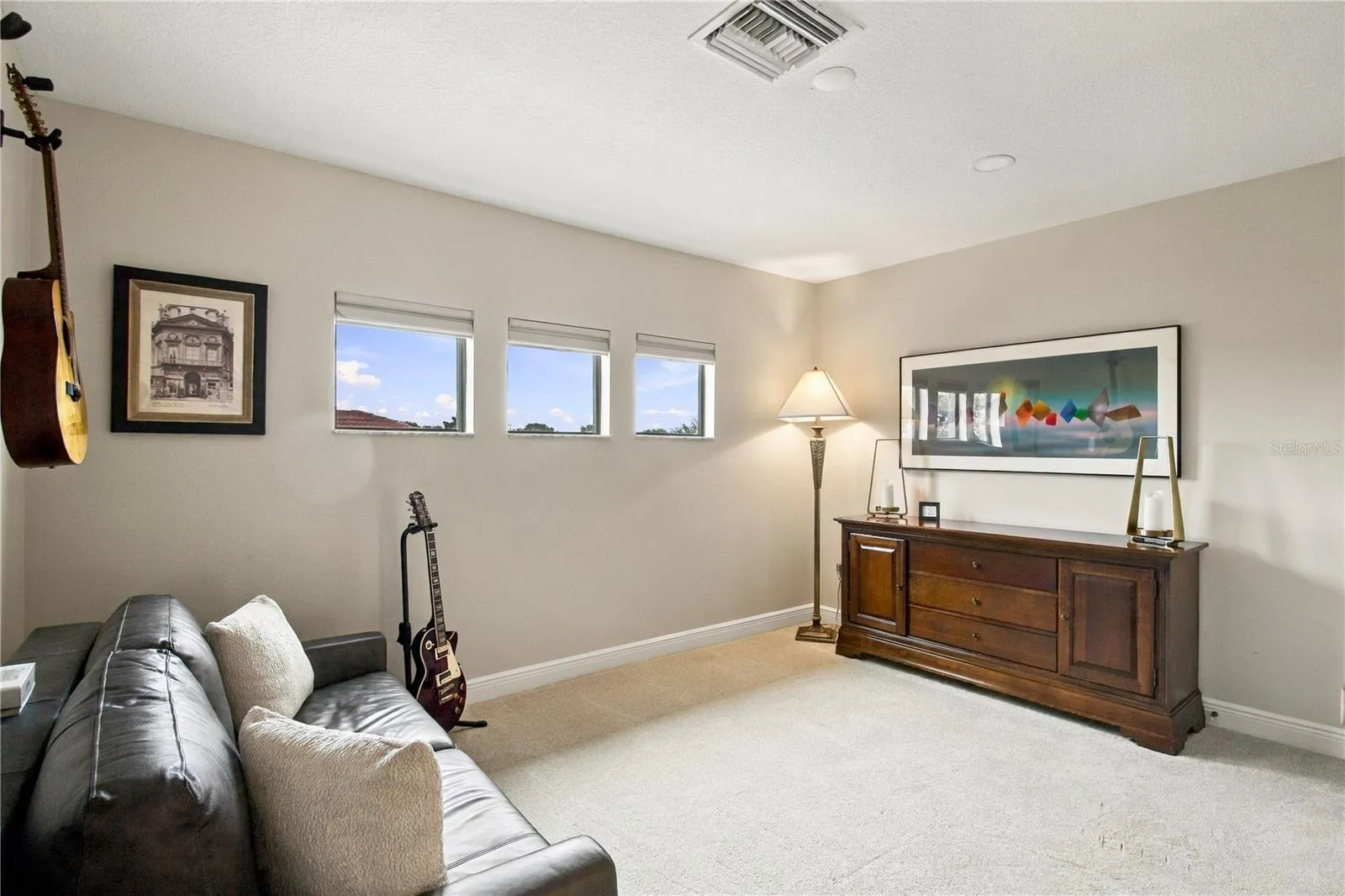 Bonus room with sofa and accent lighting