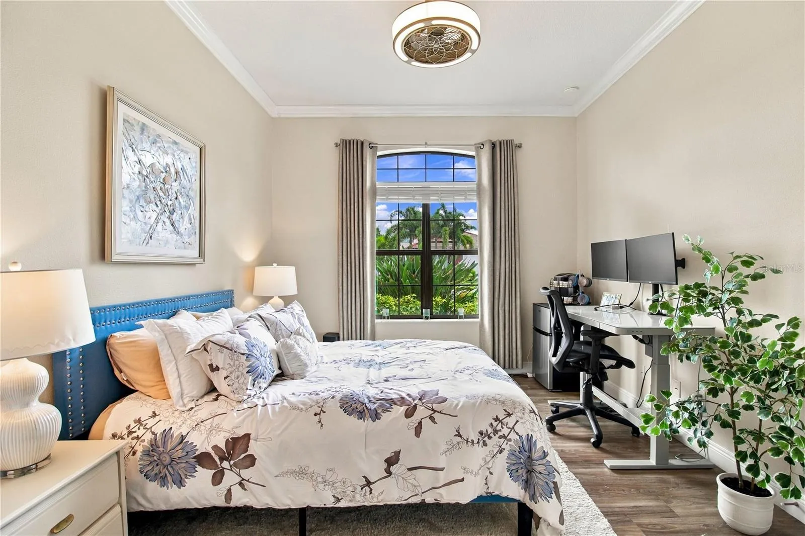 Bedroom with red accent pillows and window