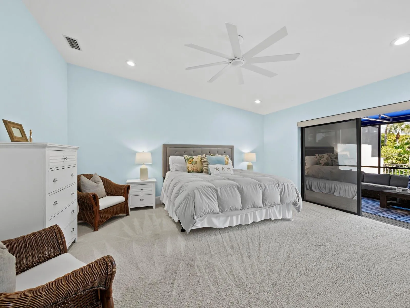 The primary bedroom has motorized privacy shades