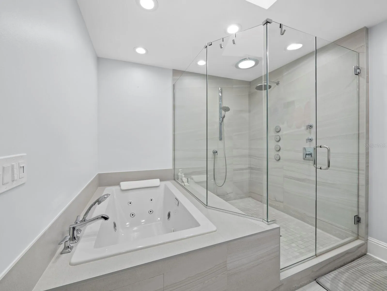 With its jetted jacuzzi tub and rainforest frameless shower
