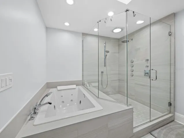 With its jetted jacuzzi tub and rainforest frameless shower
