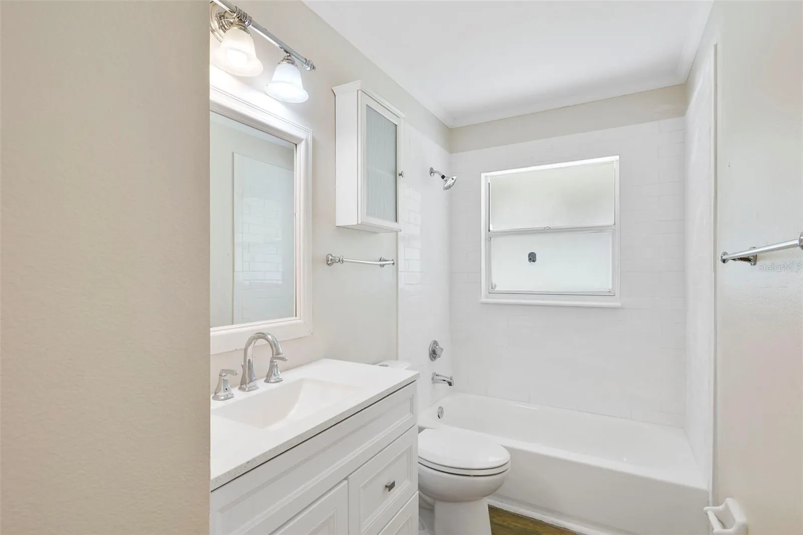 Guest bath with storage cabinet and updated vanity