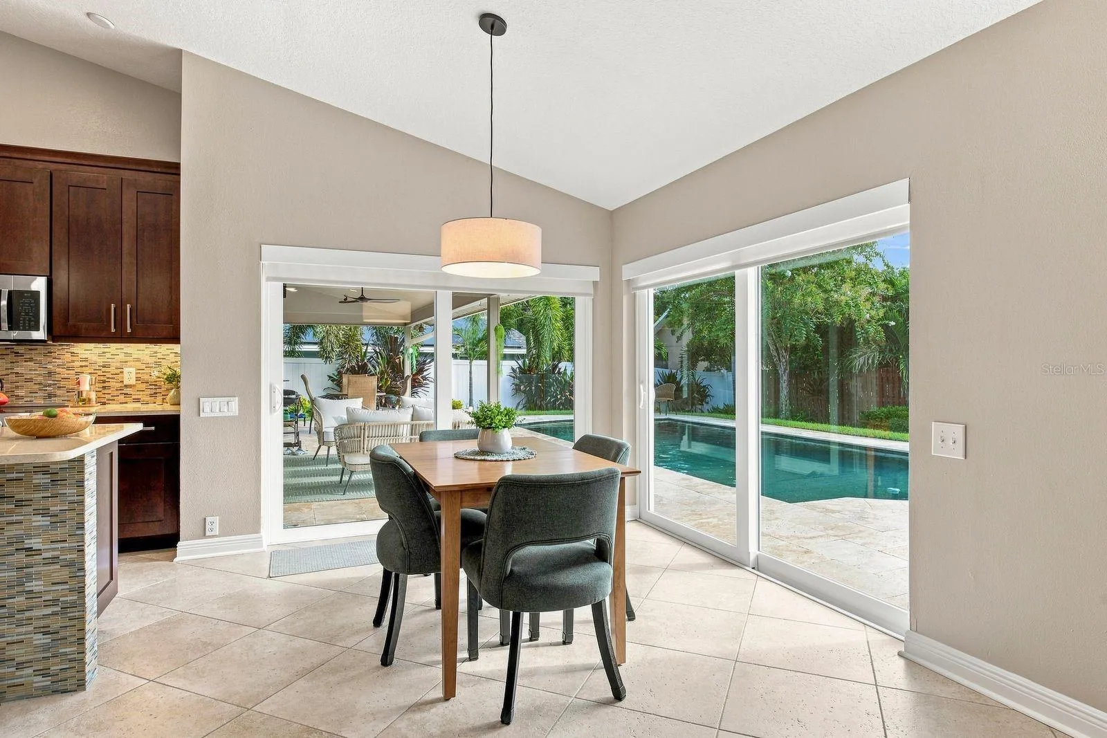 Dinette with impact sliders, new blinds facing the stunning pool