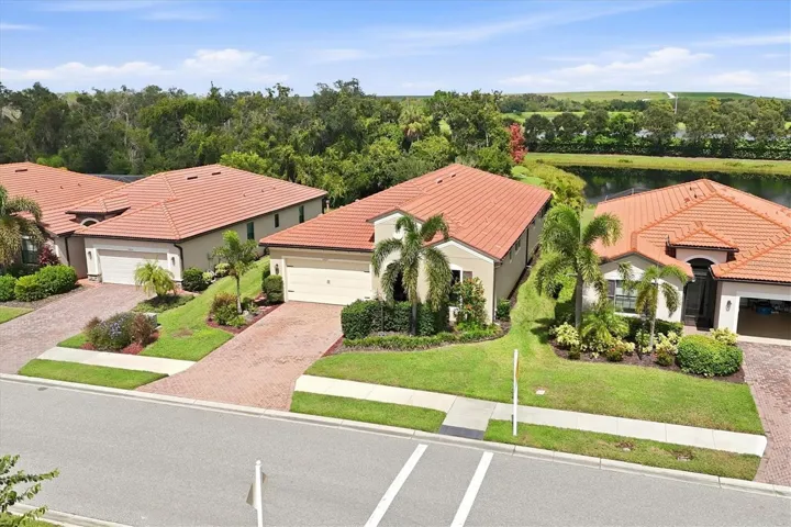 Aerial view of the home and surrounding neighborhood, showcasing the attractive Florida residential setting and mature landscaping.