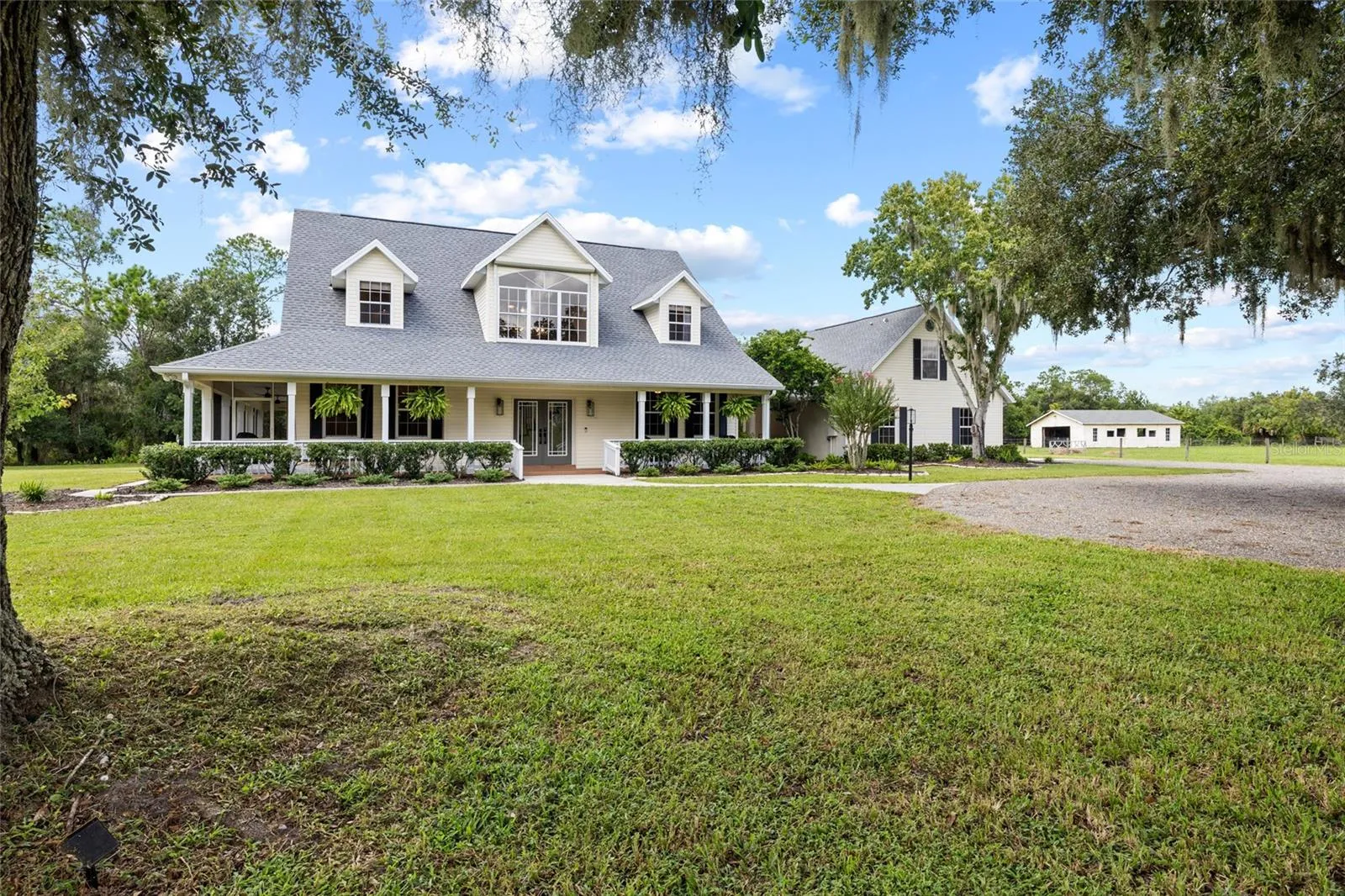 House looking toward garage and barn