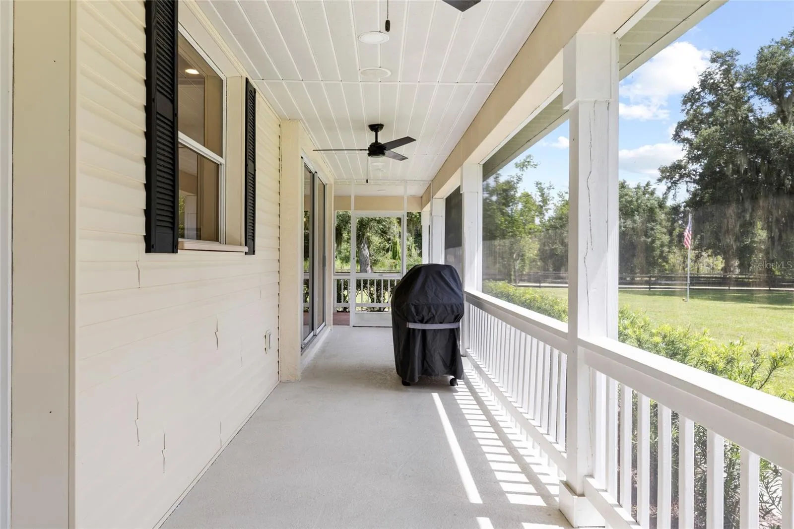 side wrap around porch looking toward front swing and front of property.