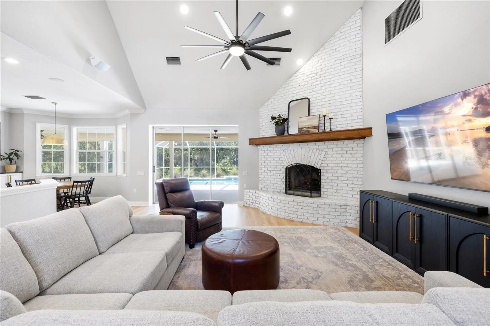 Great room looking toward pool, kitchen and nook area.