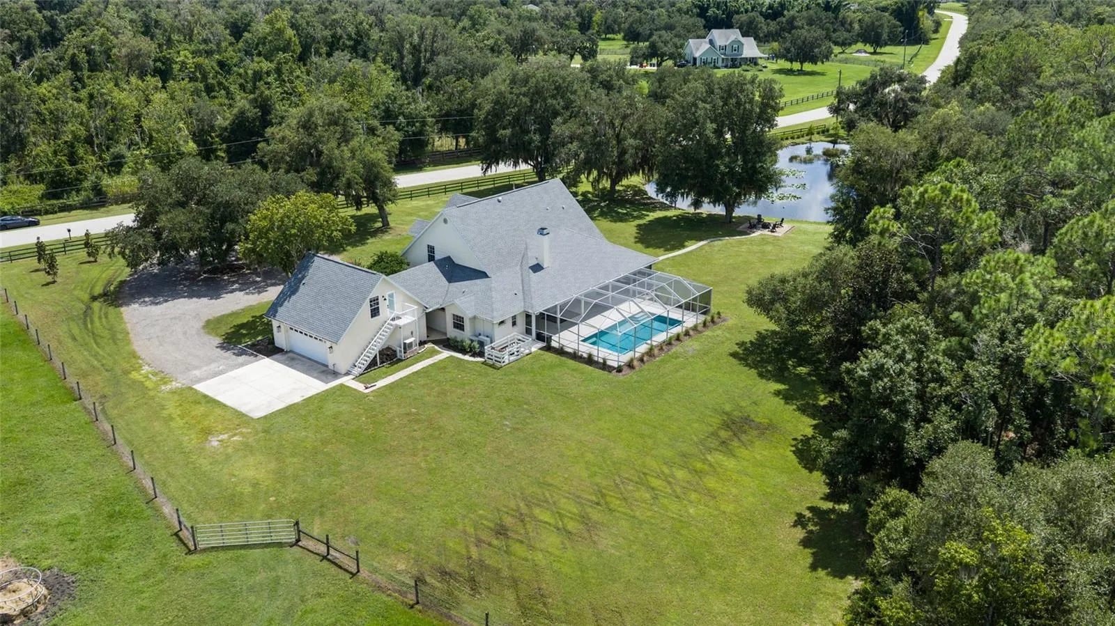 Aerial view. Shows pond and fully fenced property.