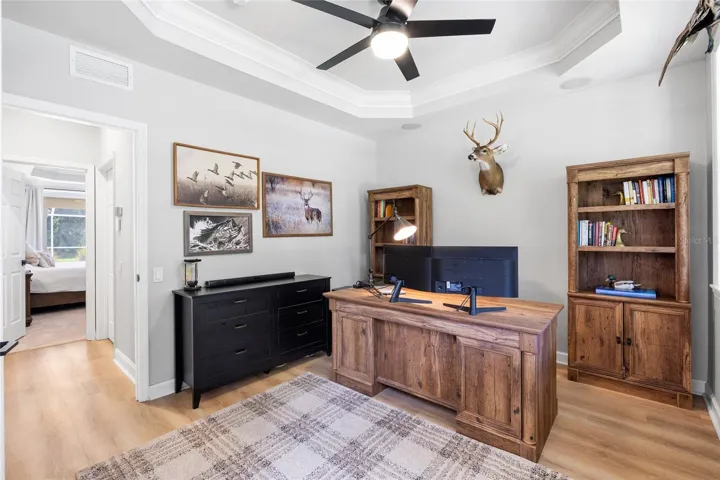 Bedroom / office / den looking toward half bath and hallway