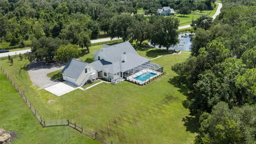 Aerial view. Shows pond and fully fenced property.