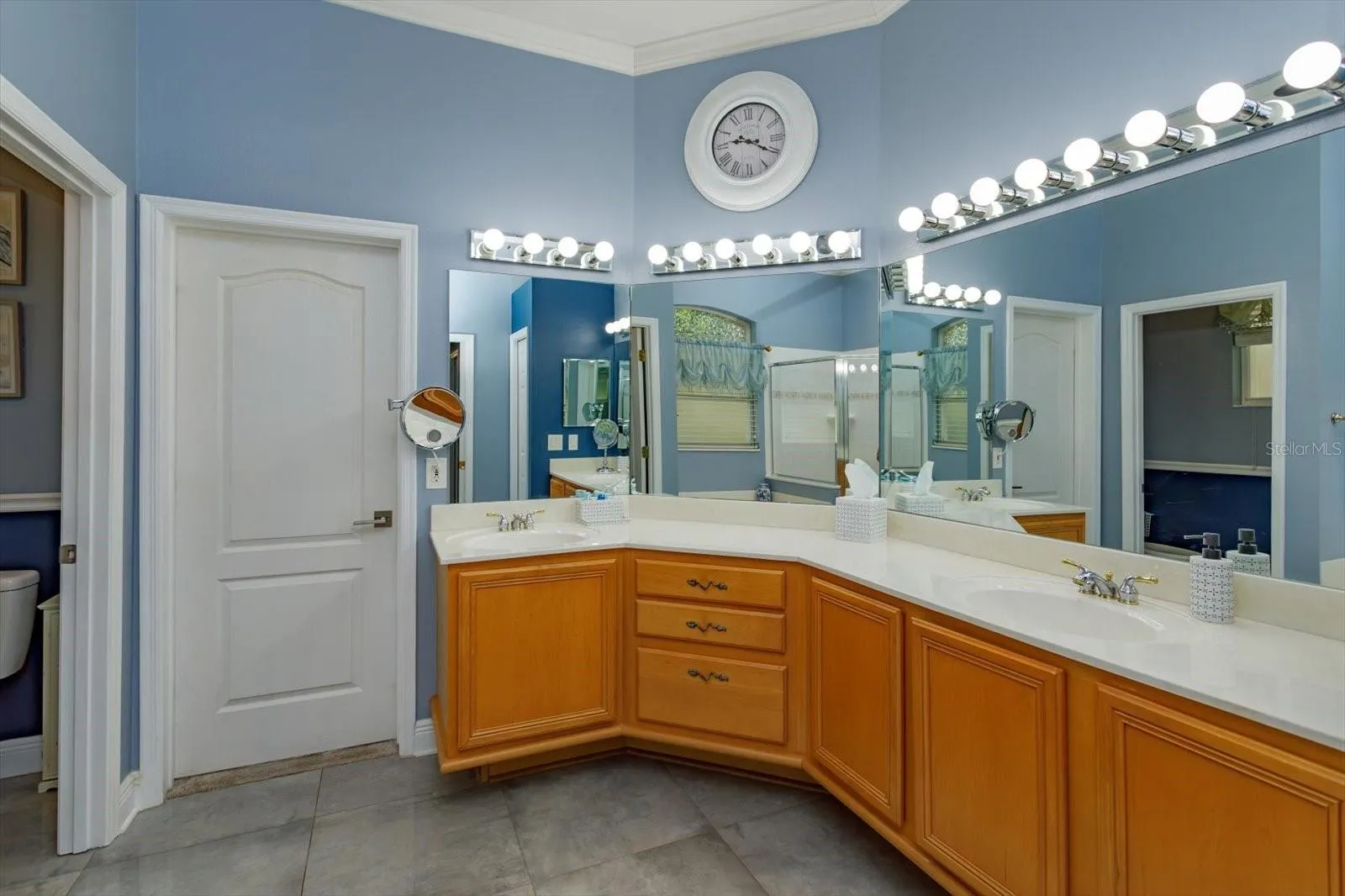 Primary bath with dual sinks and direct access to bedroom 2