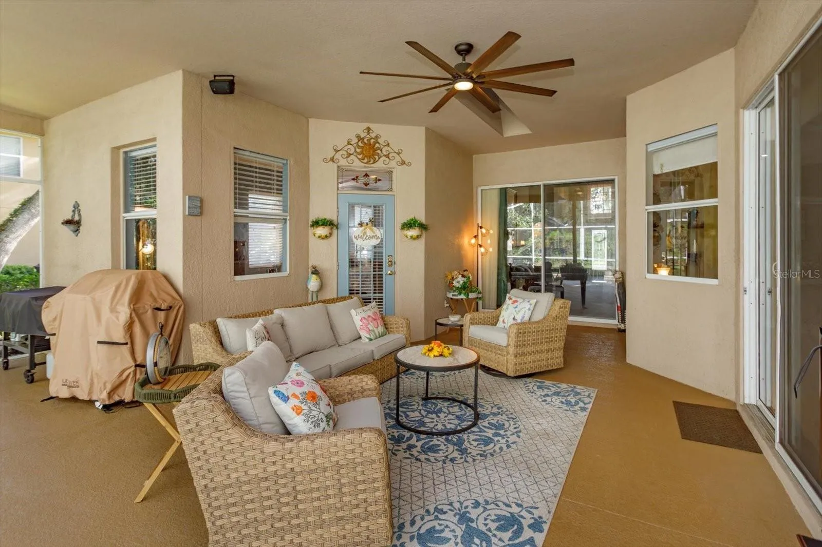 covered lanai open to living room, family room, and primary suite