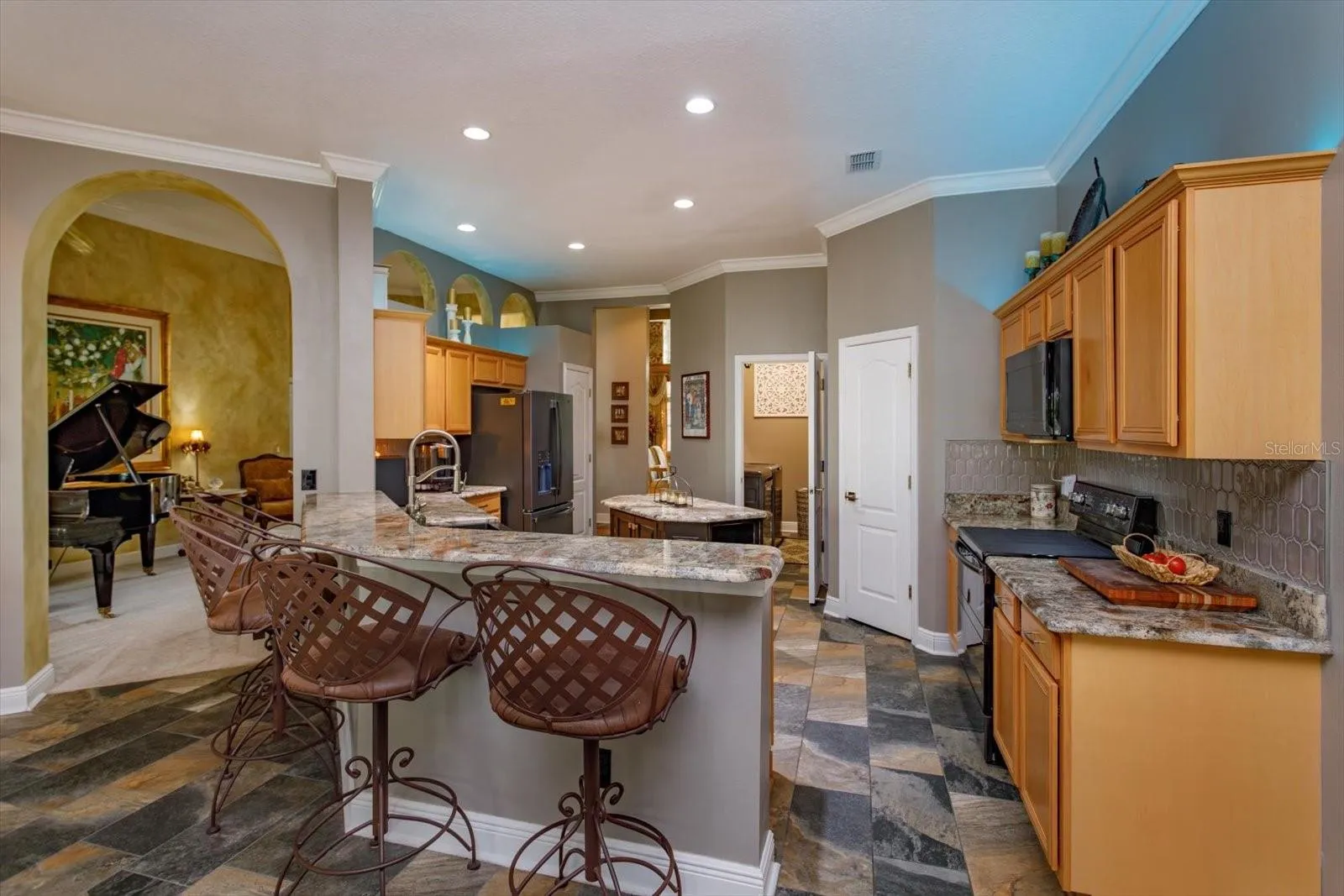 Kitchen updated with rich granite countertops and slate look tile flooring