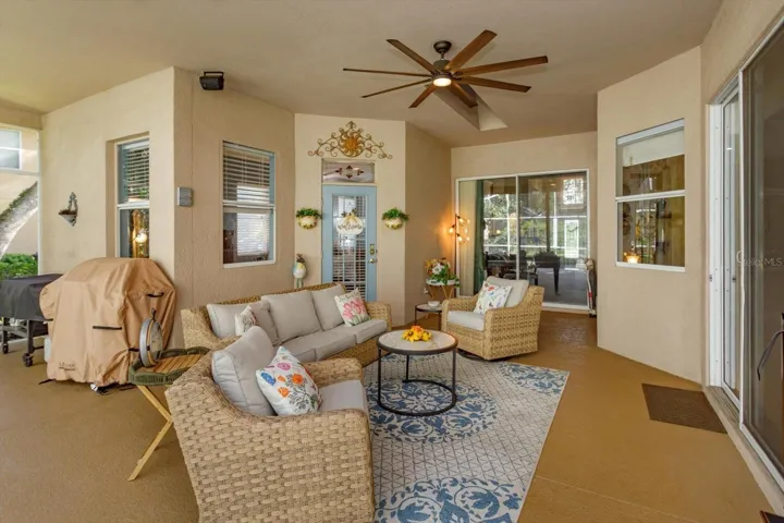 covered lanai open to living room, family room, and primary suite