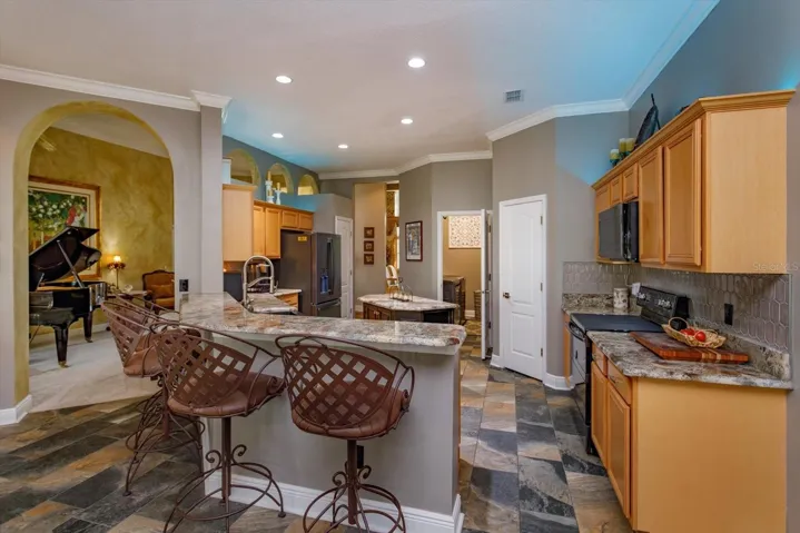 Kitchen updated with rich granite countertops and slate look tile flooring