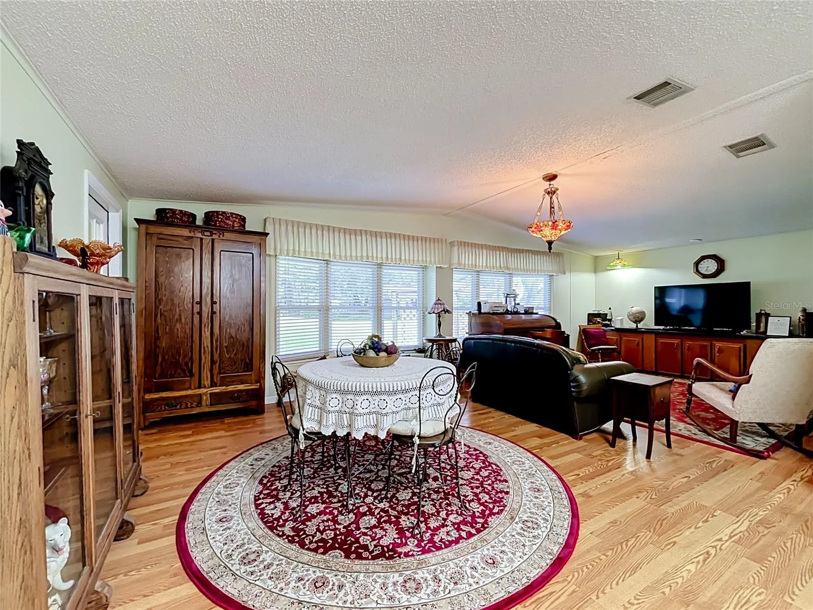 Formal dining room adjoins the formal living room with views of the golf course