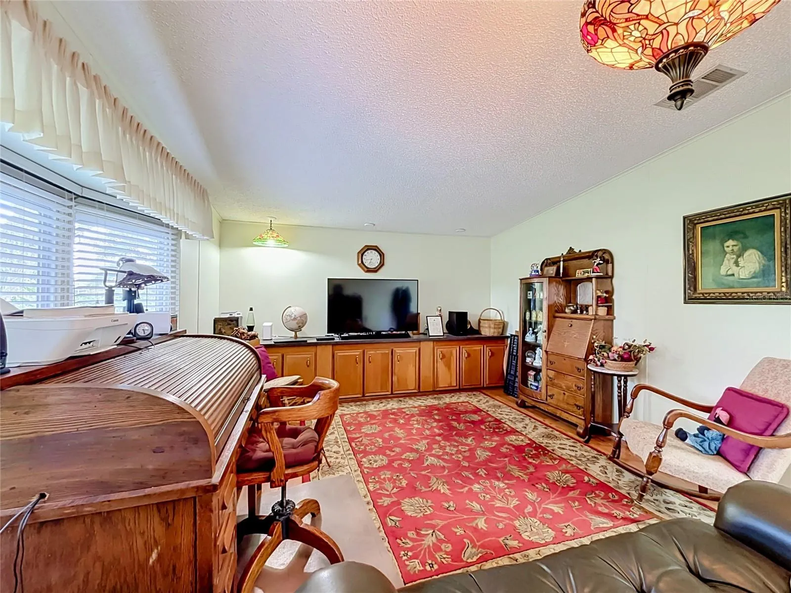Built in cabinetry provides lots of storage in the living room