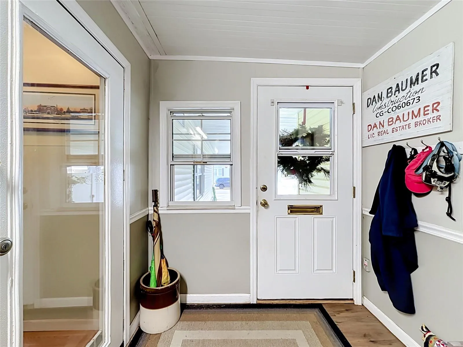 Hallways provides access into the main home and leads to te storage rooms and screen room to the rear of the property