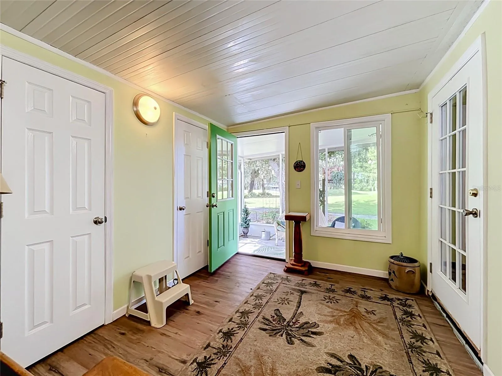 Hallway leads to rear of the property with storage rooms and access to the ground floor screened area