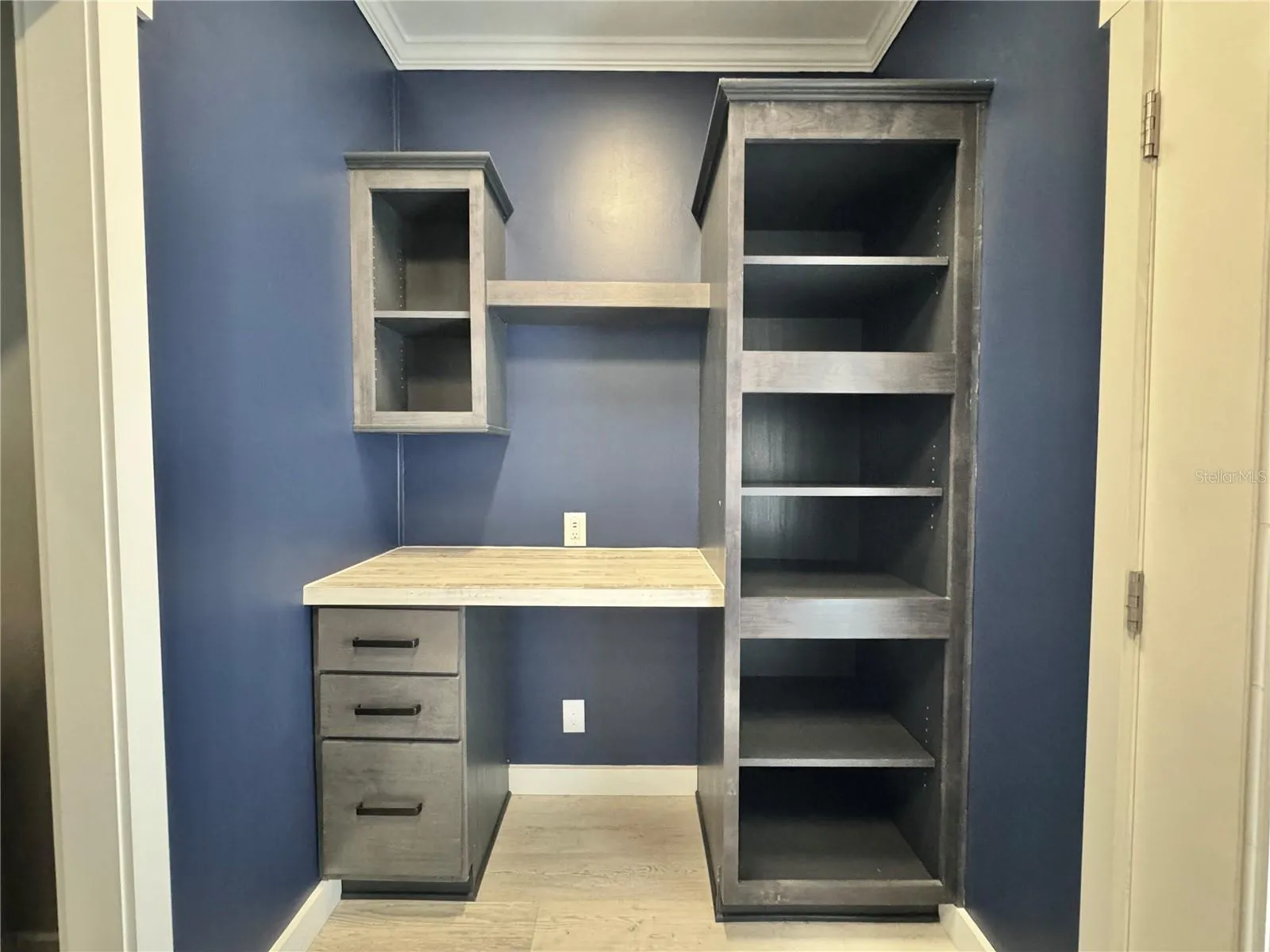 Bult-in desk and shelves in laundry room.