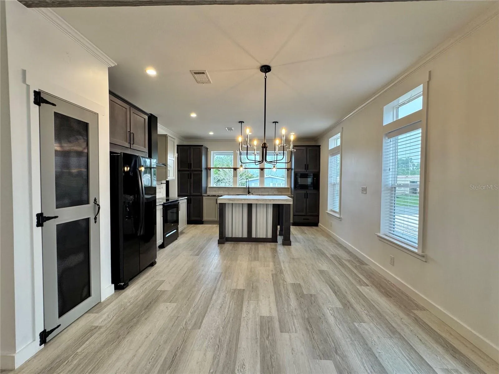 The dining room separates the kitchen and living room.