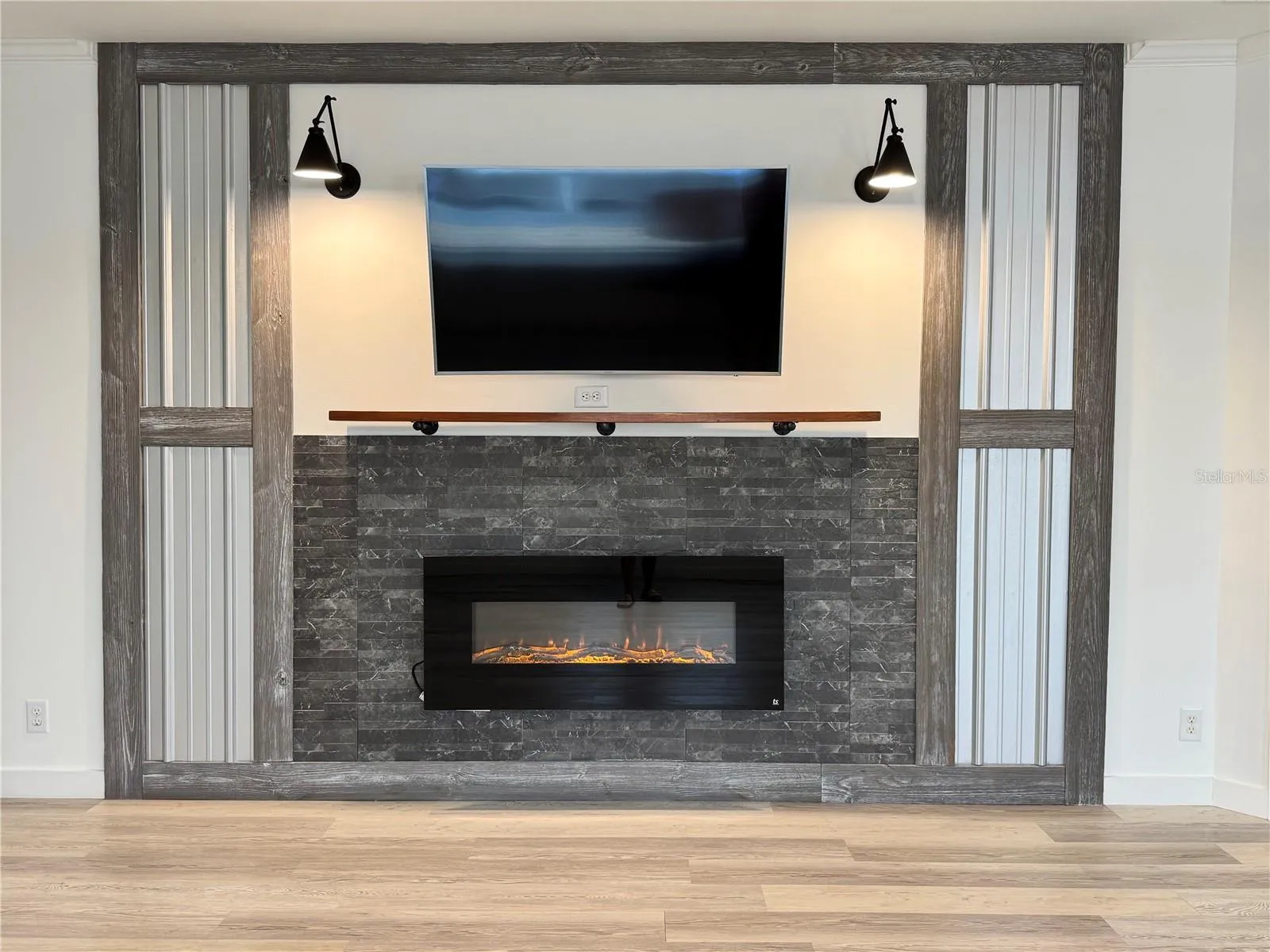 Fireplace with wall-mounted tv above it.