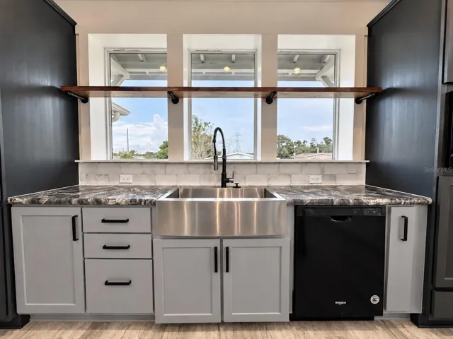 Farm sink under the bank of windows.