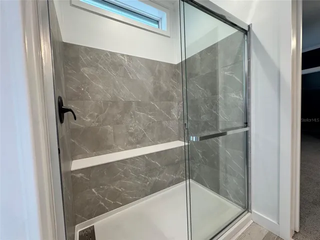 Primary shower with bench.
