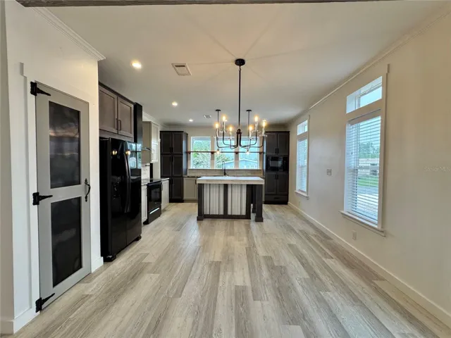 The dining room separates the kitchen and living room.