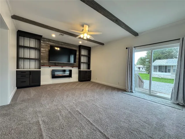 Family room with sliding glass doors to the rear part of the yard.