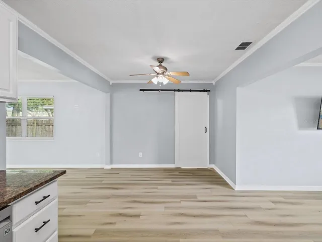 Kitchen area view to dining area and 2nd bathroom/laundry room