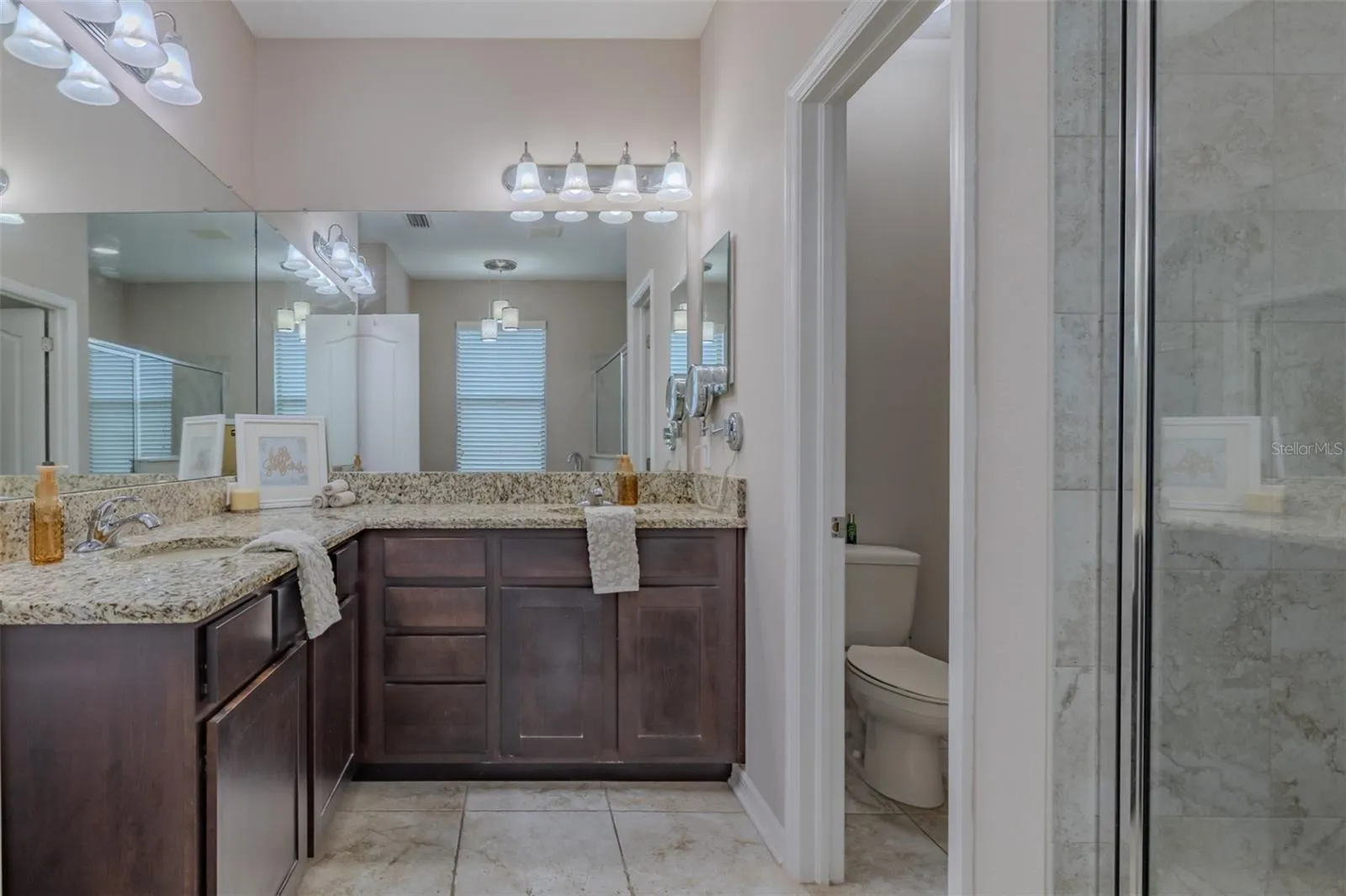 Primary bathroom with his & hers sinks with a water closet