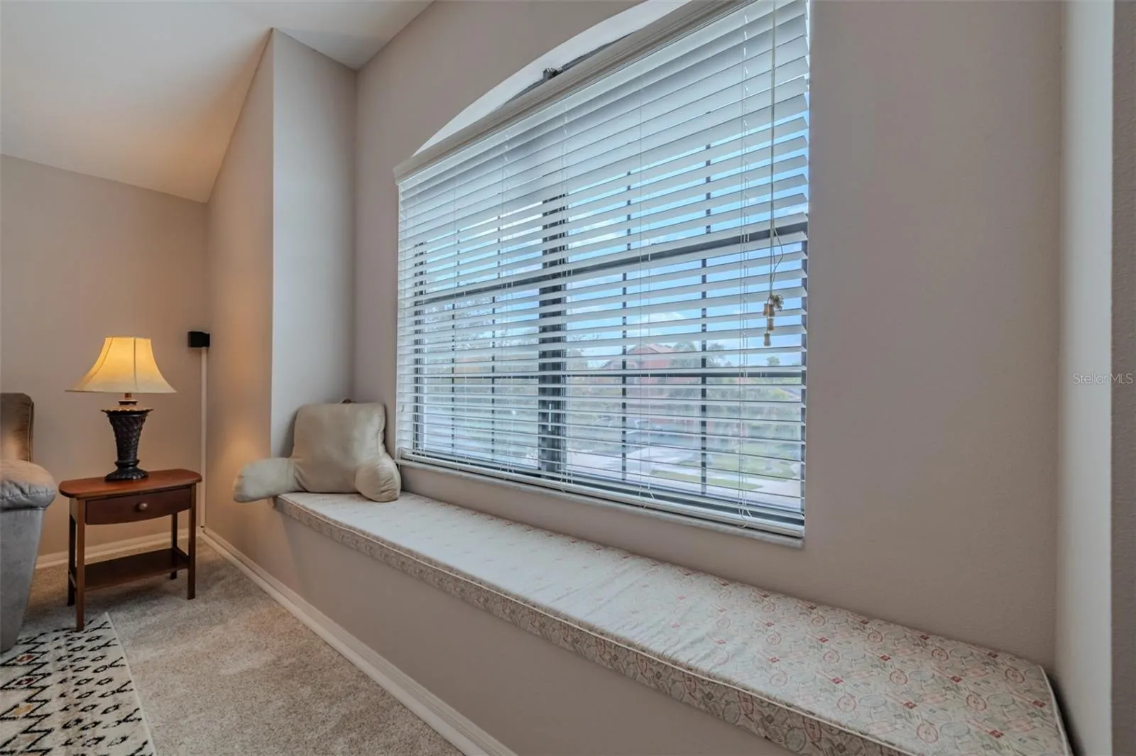 Awesome bonus room with a lovely window seat. Bonus room sofa and TV stand convey.