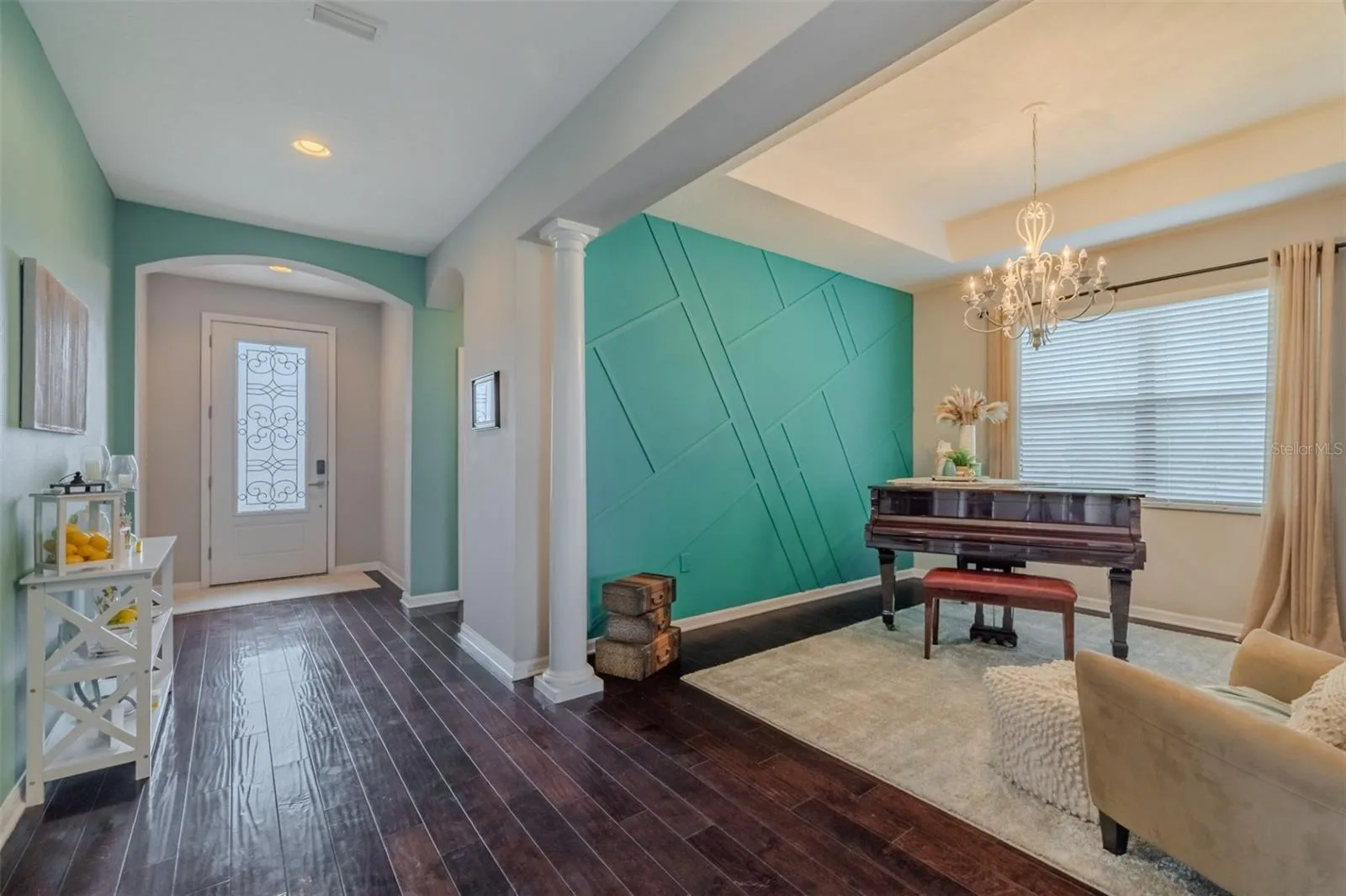 Entry way with formal dining room used as piano room