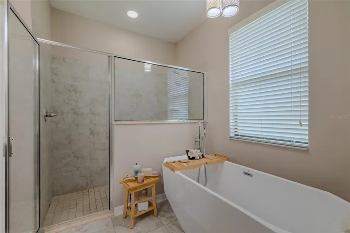 Primary soaking tub with large shower