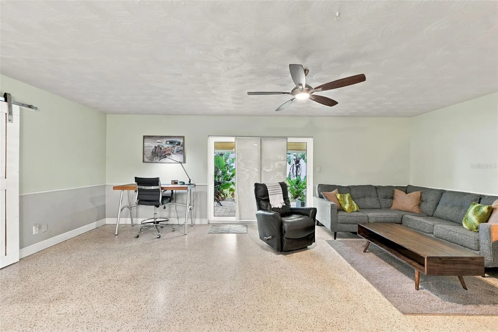 Spacious living room with sliding doors to backyard.