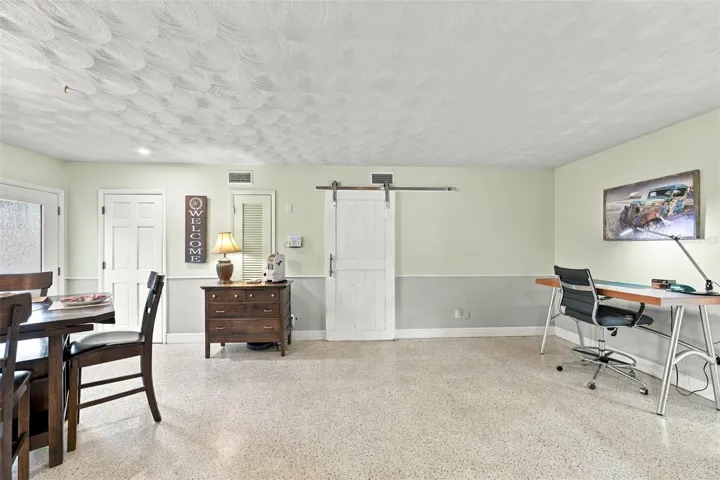 Barn door closing off bathroom and 2-bedrooms.